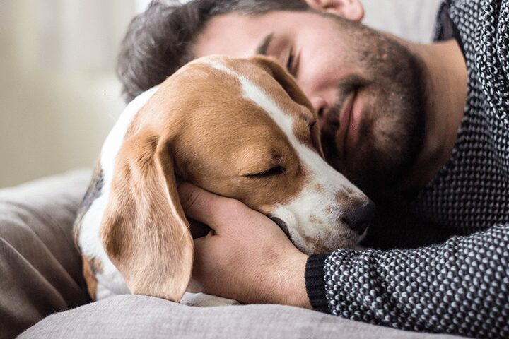 man hugging dog